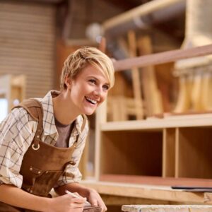 female apprentice working as carpenter in furniture workshop jpg